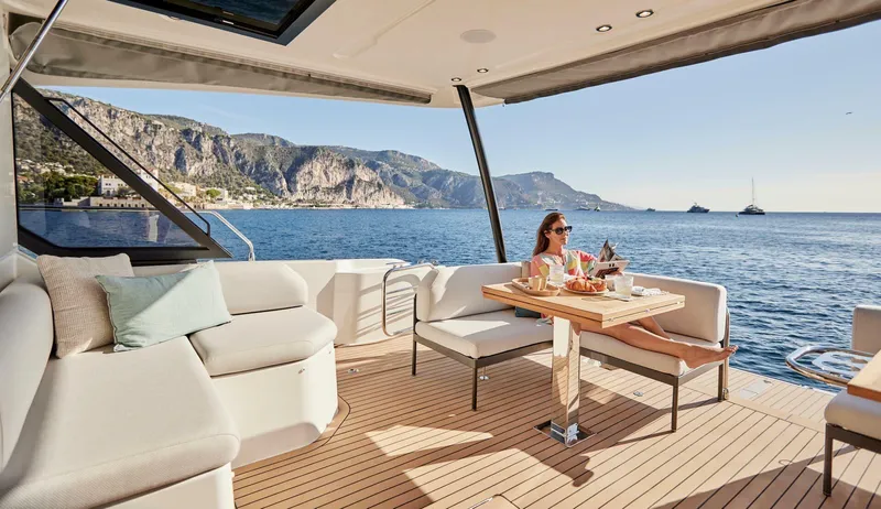 Slide: The Image of Luxury 2024 Prestige M48 yacht with scenic ocean view and elegant outdoor seating area. - 6