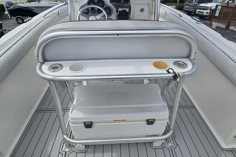 Slide: The Image of 2004 Wellcraft 252 Fisherman boat interior with console and cooler storage. - 10