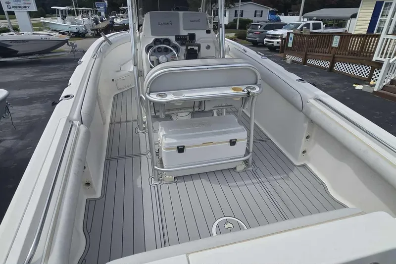 Slide: The Image of 2004 Wellcraft 252 Fisherman boat interior with console and seating, docked at marina. - 12