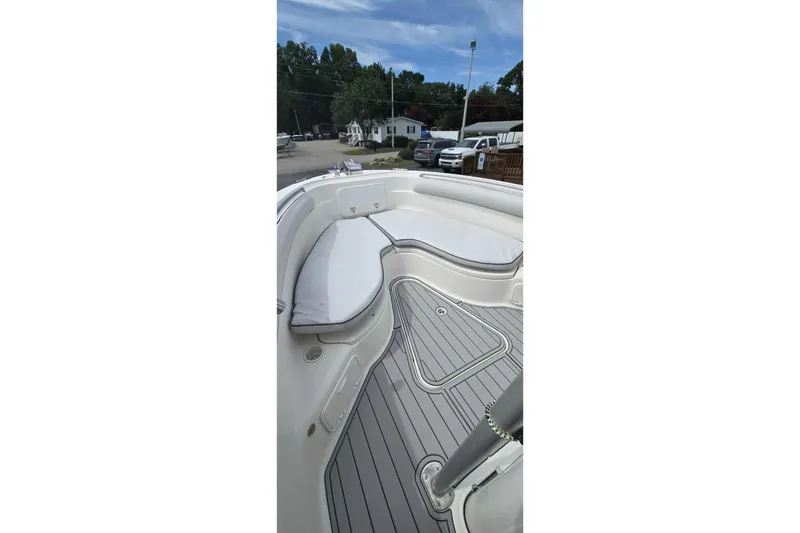 Slide: The Image of 2004 Wellcraft 252 Fisherman boat interior with cushioned seating and sleek flooring. - 16