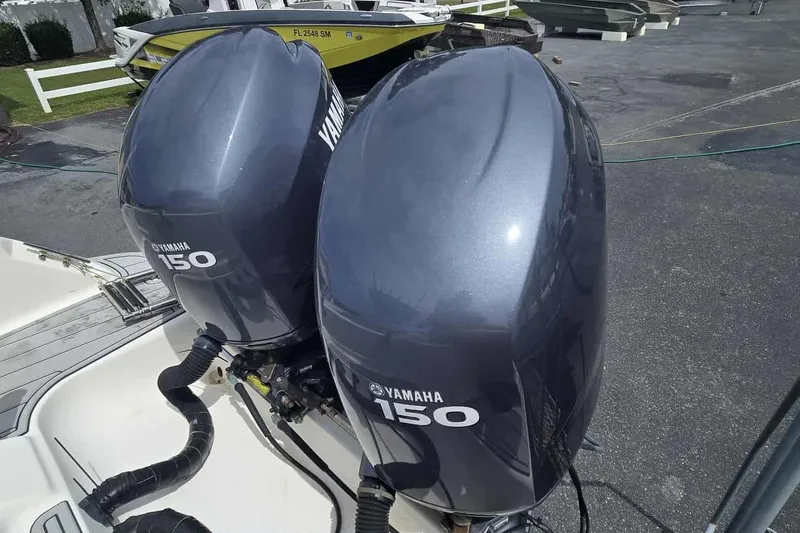 Slide: The Image of Twin Yamaha 150 outboard engines on a 2004 Wellcraft 252 Fisherman boat. - 19