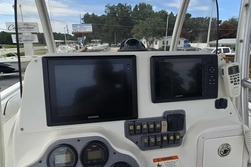 Slide: The Image of Control panel of a 2004 Wellcraft 252 Fisherman boat with Garmin displays. - 6