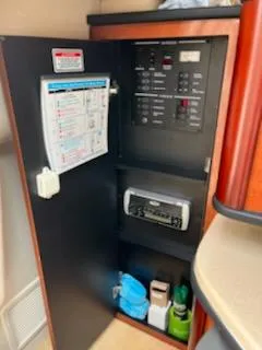Slide: The Image of Electrical panel and storage inside a 2005 Sea Ray 270 Amberjack boat. - 16