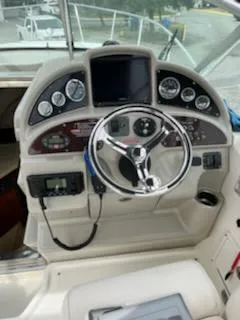 Slide: The Image of 2005 Sea Ray 270 Amberjack boat dashboard with steering wheel and gauges. - 17