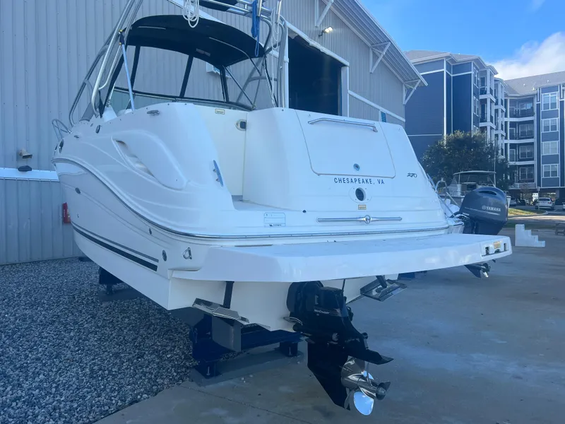 Slide: The Image of 2005 Sea Ray 270 Amberjack boat docked near a marina building. - 25