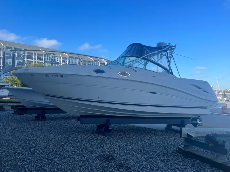 Slide: The Image of 2005 Sea Ray 270 Amberjack boat on dry dock with blue sky background. - 28