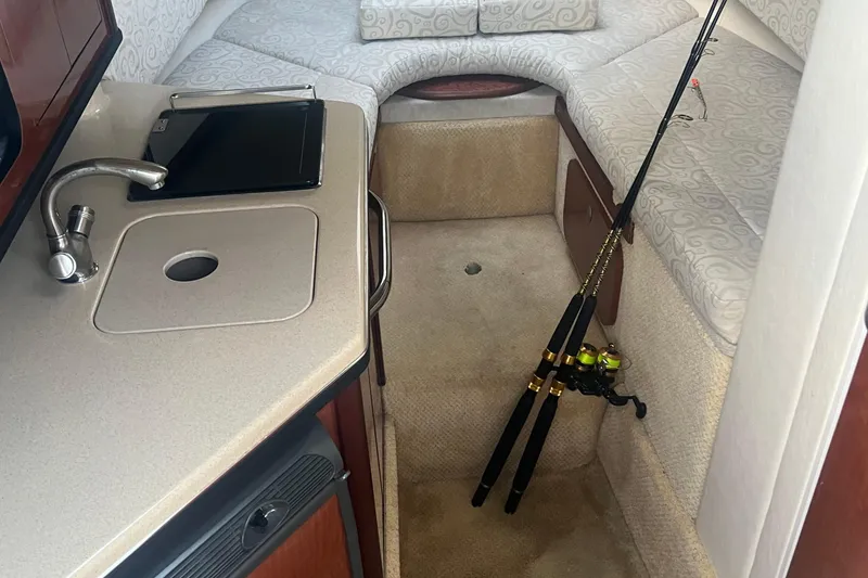 Slide: The Image of Interior of 2005 Sea Ray 270 Amberjack with kitchenette and fishing rods. - 39