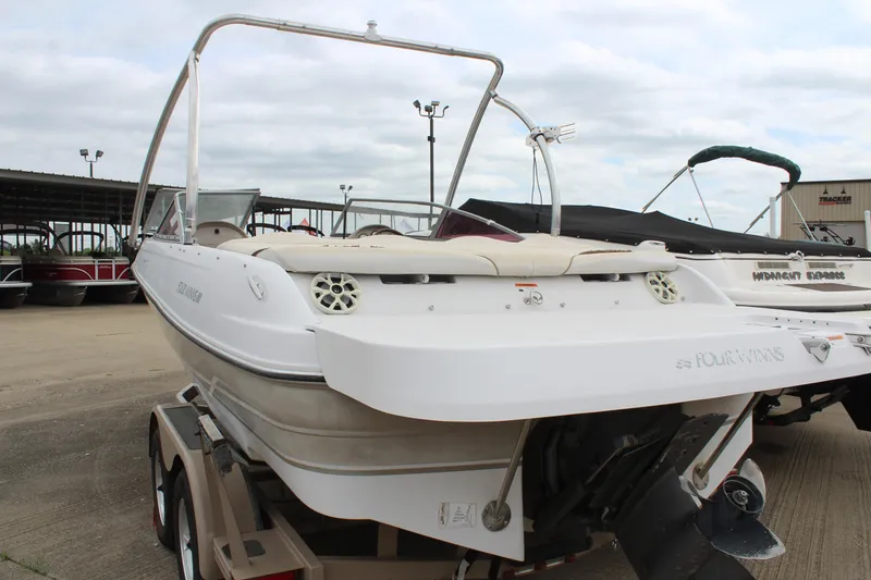 Slide: The Image of 2005 Four Winns HORIZON 200 boat on trailer, rear view, in a marina setting. - 13
