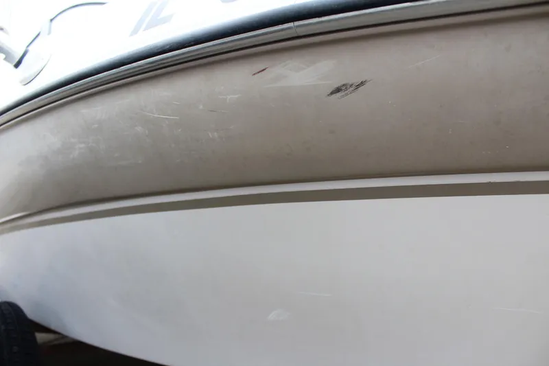 Slide: The Image of 2005 Four Winns HORIZON 200 boat hull with visible scratches and marks. - 17