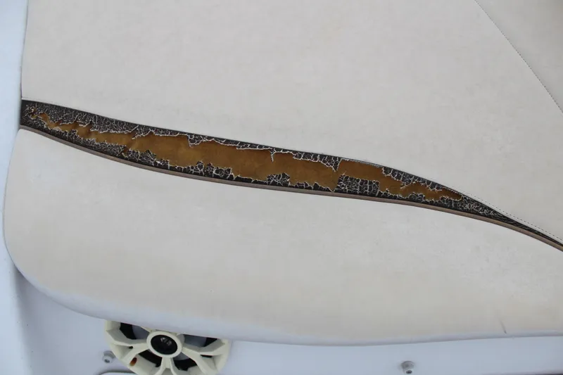 Slide: The Image of Torn upholstery on 2005 Four Winns HORIZON 200 boat seat, revealing wear and damage. - 19