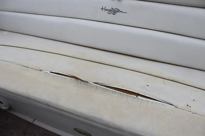 Slide: The Image of Torn upholstery on 2005 Four Winns HORIZON 200 boat seat. - 21