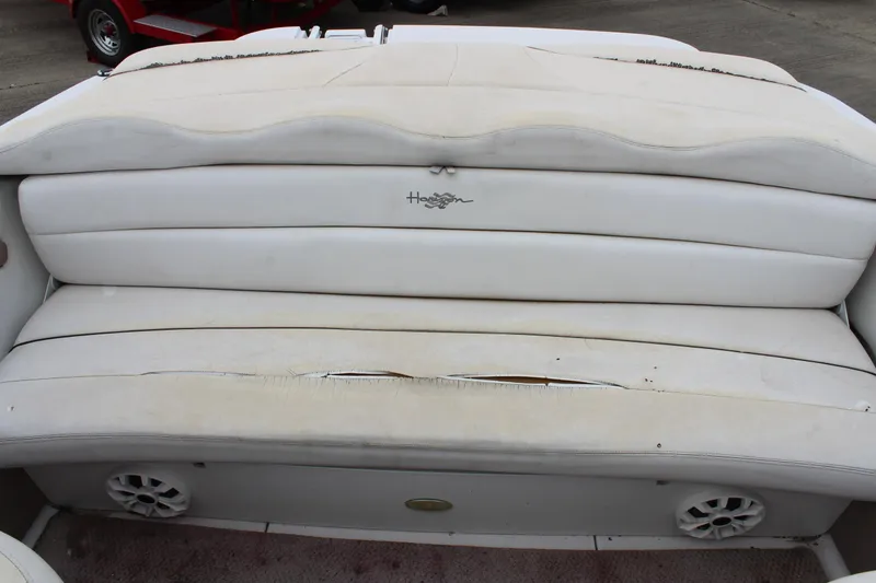 Slide: The Image of 2005 Four Winns HORIZON 200 boat seating with visible wear and built-in speakers. - 22