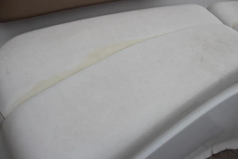 Slide: The Image of 2005 Four Winns HORIZION 200 boat seat with visible wear and discoloration. - 28