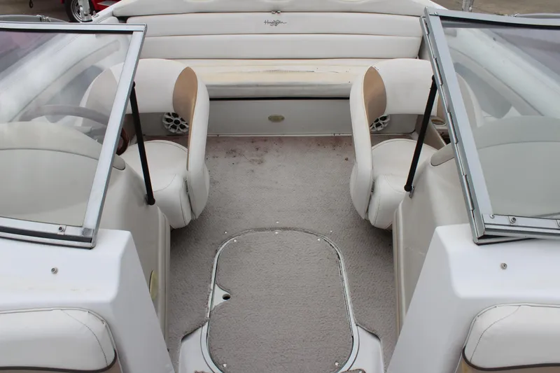 Slide: The Image of 2005 Four Winns HORIZON 200 boat interior with beige seating and open windshield. - 30
