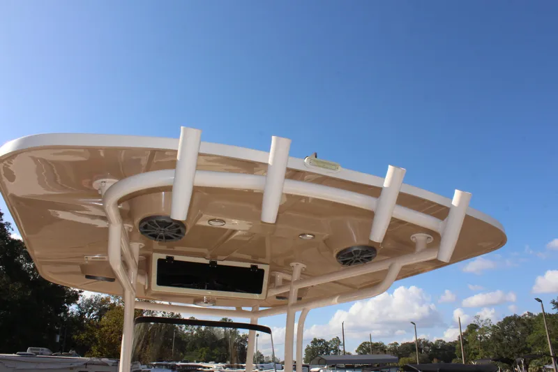 Slide: The Image of 2023 Sea Chaser 27 HFC boat roof with rod holders and speakers under clear sky. - 20