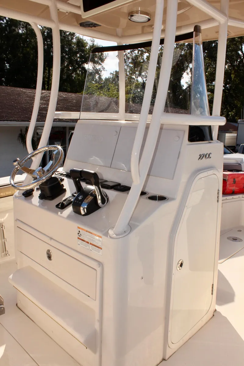 Slide: The Image of 2023 Sea Chaser 27 HFC boat console with steering wheel and controls. - 21
