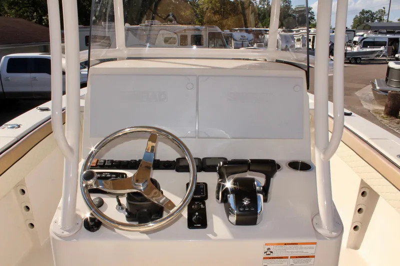 Slide: The Image of 2023 Sea Chaser 27 HFC boat console with steering wheel and controls. - 22