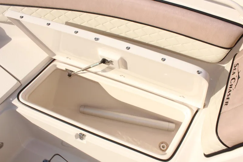 Slide: The Image of 2023 Sea Chaser 27 HFC boat storage compartment with cushioned seating. - 35