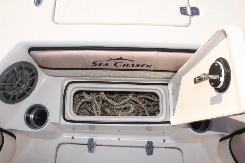 Slide: The Image of 2023 Sea Chaser 27 HFC boat storage compartment with ropes and speaker. - 38