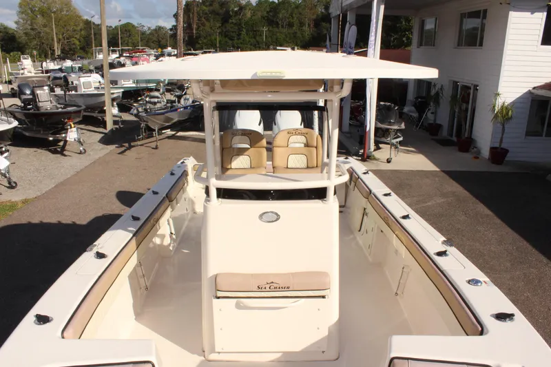 Slide: The Image of 2023 Sea Chaser 27 HFC boat at a marina, showcasing spacious deck and seating. - 41