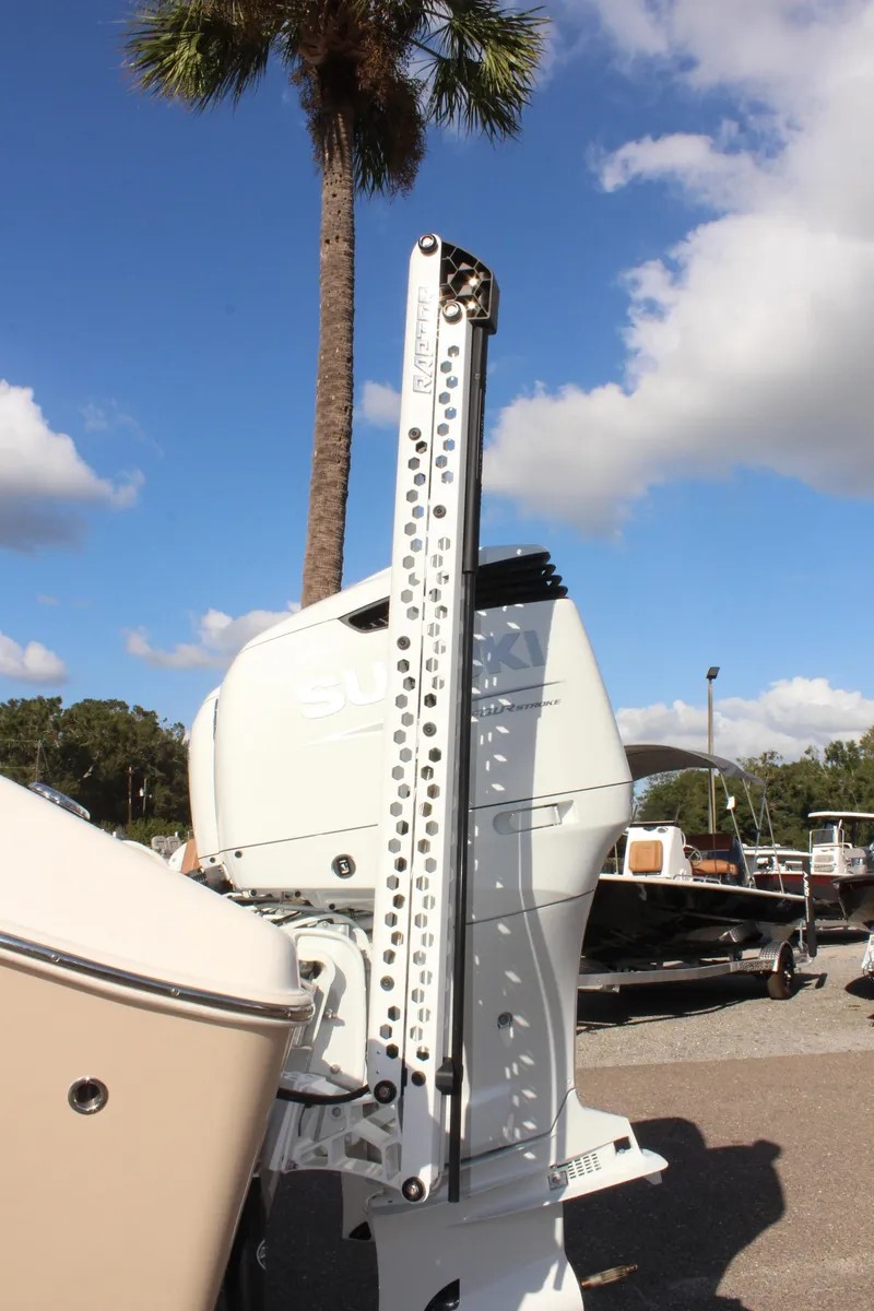 Slide: The Image of 2023 Sea Chaser 27 HFC boat engine detail with palm tree and blue sky. - 44