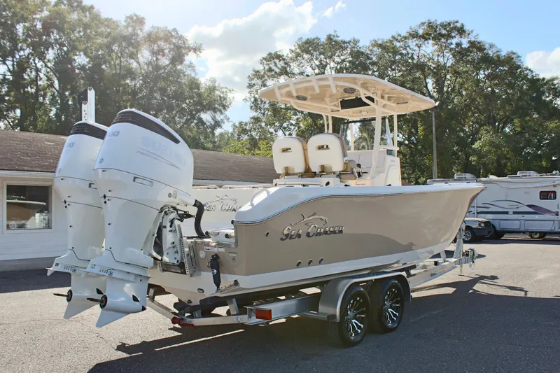 Slide: The Image of 2023 Sea Chaser 27 HFC boat on trailer with dual engines, parked outdoors. - 7