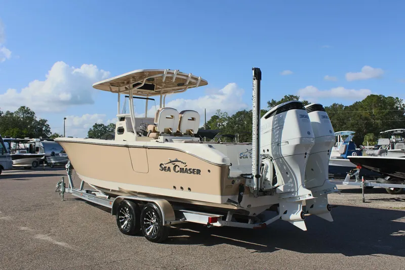 Slide: The Image of 2023 Sea Chaser 27 HFC boat on trailer, dual engines, parked outdoors. - 9