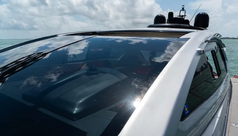 Slide: The Image of 2013 Azimut Atlantis 58 yacht with sleek design and reflective windows on a sunny day. - 18