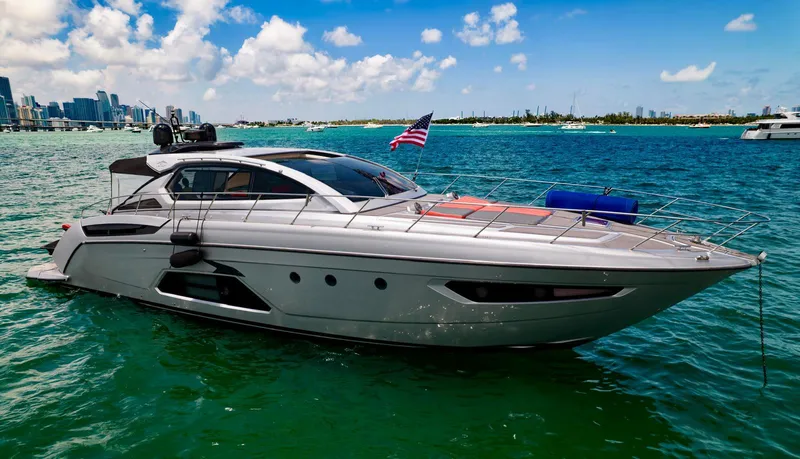Slide: The Image of 2013 Azimut Atlantis 58 yacht on vibrant green water with American flag. - 2