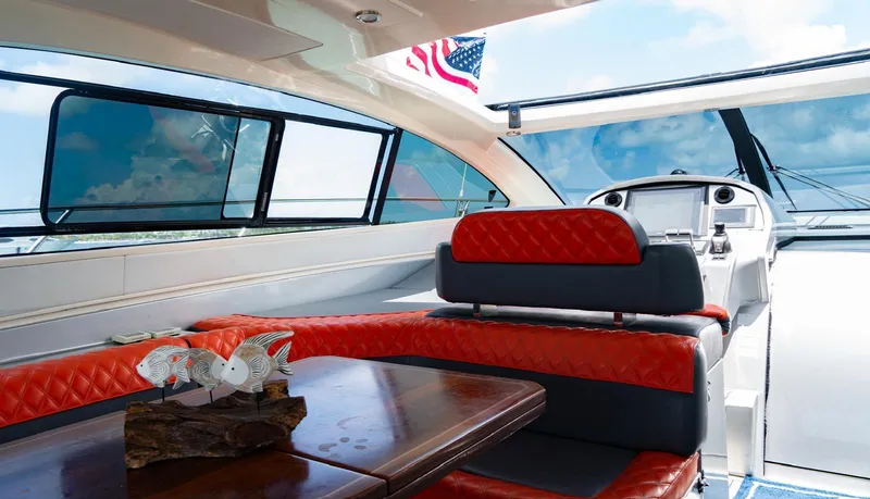 Slide: The Image of Interior of 2013 Azimut Atlantis 58 yacht with red seating and wooden table. - 22