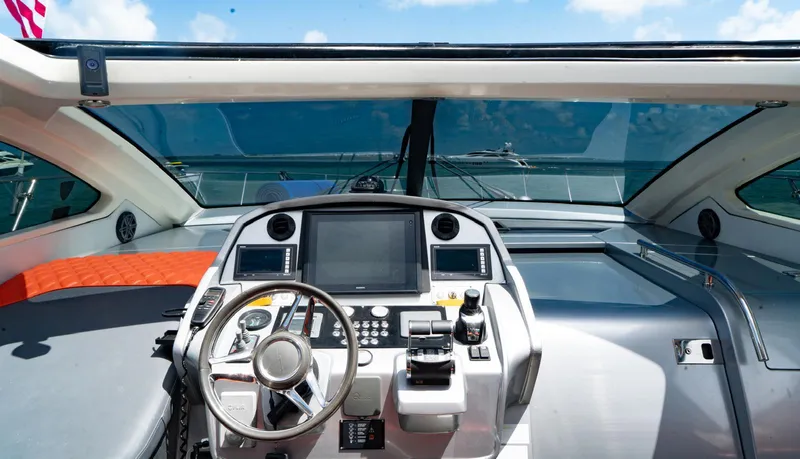 Slide: The Image of Cockpit view of 2013 Azimut Atlantis 58 yacht with modern controls and ocean backdrop. - 28