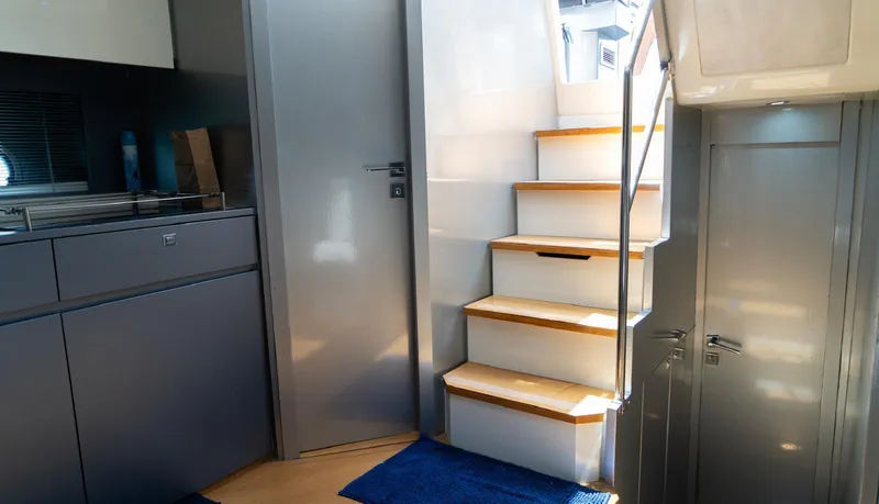Slide: The Image of Interior of 2013 Azimut Atlantis 58 yacht, featuring modern stairs and sleek cabinetry. - 32