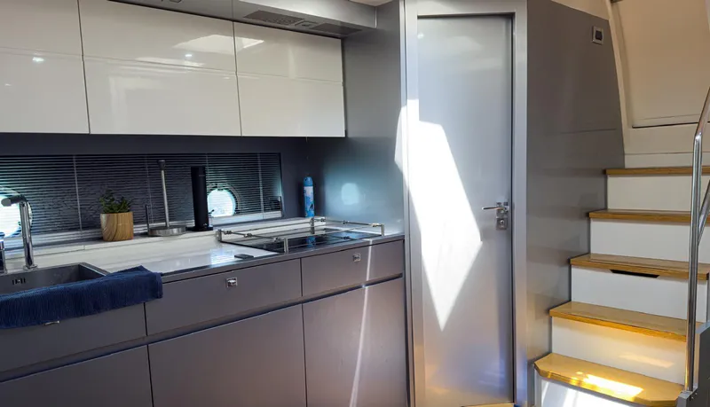 Slide: The Image of Modern kitchen interior of 2013 Azimut Atlantis 58 yacht with sleek cabinetry and stairs. - 34