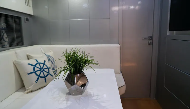 Slide: The Image of Interior of 2013 Azimut Atlantis 58 yacht with modern decor and nautical-themed cushions. - 39