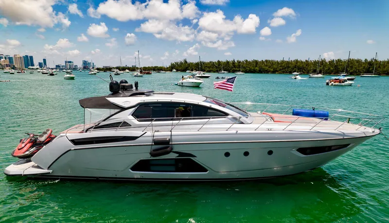 Slide: The Image of Azimut Atlantis 58 yacht, 2013 model, cruising in a vibrant marina under a clear blue sky. - 5