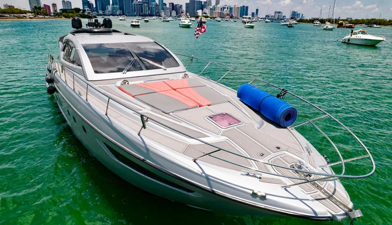 Slide: The Image of Azimut Atlantis 58 yacht, 2013 model, cruising in a vibrant harbor with city skyline backdrop. - 6