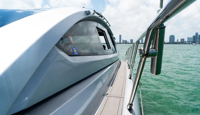 Slide: The Image of Azimut Atlantis 58 yacht, 2013 model, cruising on turquoise waters with city skyline in background. - 9