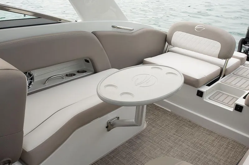 Slide: The Image of 2023 Crownline E305XS boat interior with seating and table. - 11