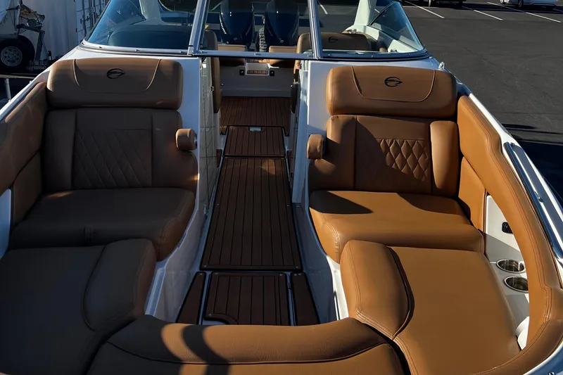 Slide: The Image of 2023 Crownline E305XS boat interior with luxurious brown leather seating. - 2