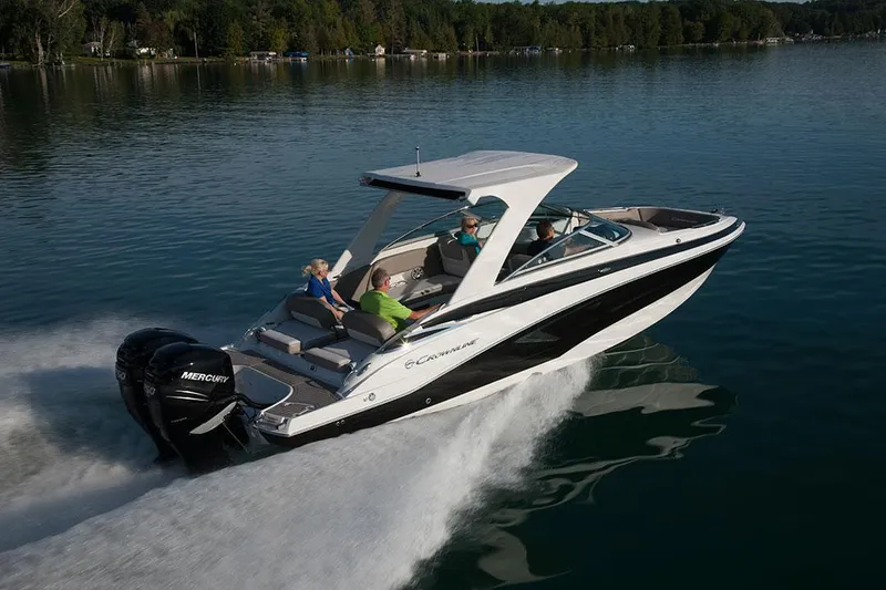Slide: The Image of 2023 Crownline E305XS boat cruising on a lake. - 6