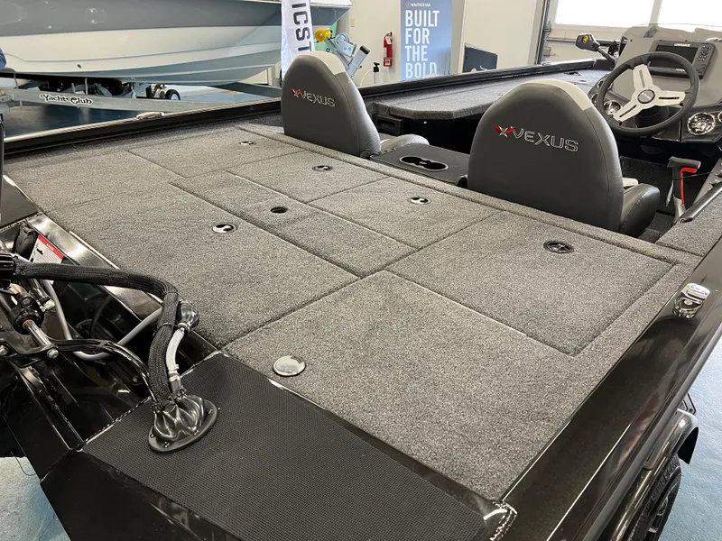Slide: The Image of 2023 Vexus AVX181 boat interior with gray carpeted deck and two seats. - 5