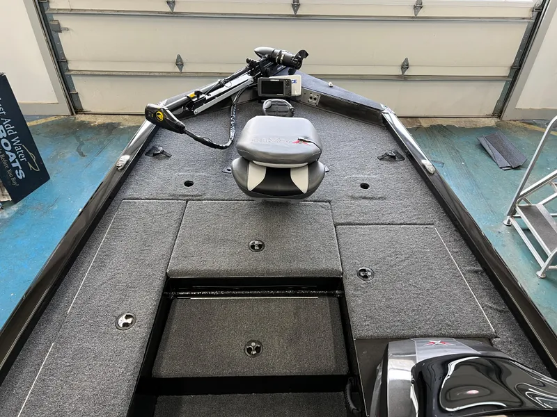 Slide: The Image of 2023 Vexus AVX181 fishing boat interior with trolling motor and storage compartments. - 7