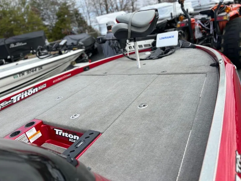 Slide: The Image of 2016 Triton 21 TrX bass boat with spacious deck and fishing seat. - 11