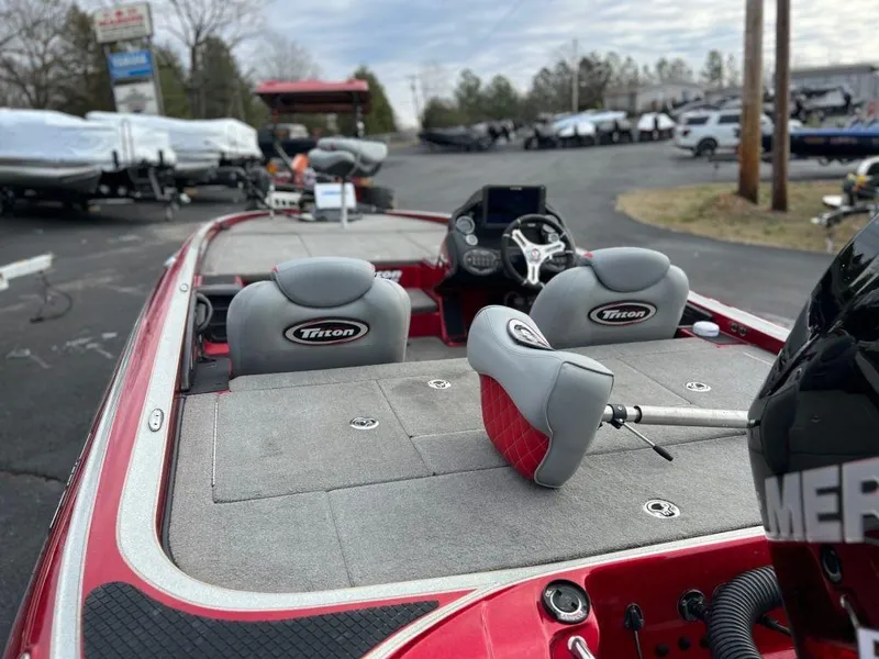 Slide: The Image of 2016 Triton 21 TrX bass boat with gray and red interior. - 6