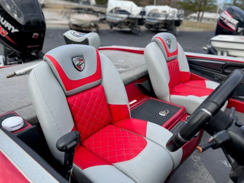 Slide: The Image of 2016 Triton 21 TrX boat interior with red and gray seats. - 9