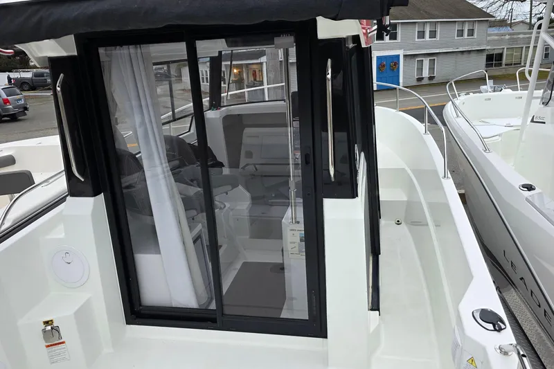 Slide: The Image of 2023 Jeanneau NC 695 Sport Serie 2 boat with sliding glass door and modern interior. - 14