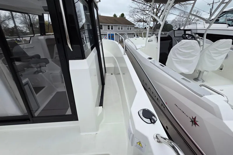 Slide: The Image of 2023 Jeanneau NC 695 Sport Serie 2 boat, side view with cockpit and seating area. - 22