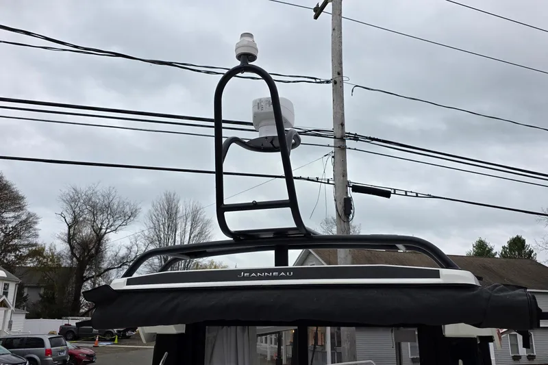 Slide: The Image of 2023 Jeanneau NC 695 Sport Serie 2 boat with radar equipment against cloudy sky. - 24