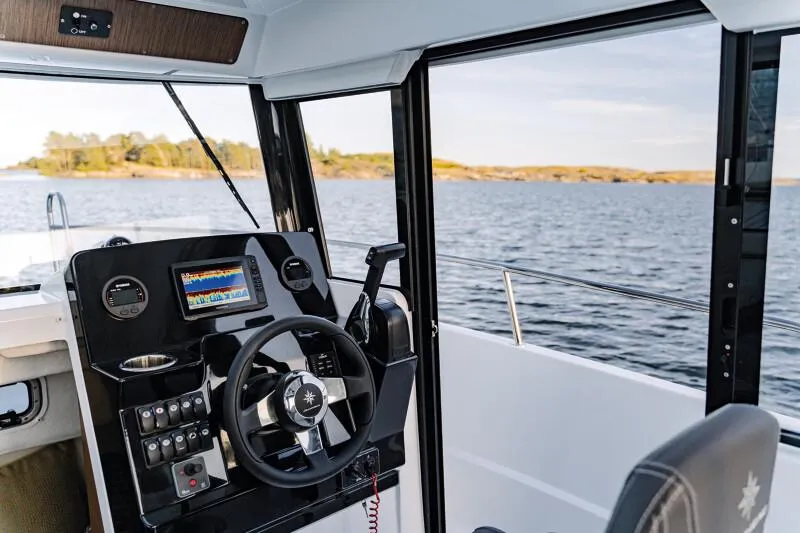 Slide: The Image of 2023 Jeanneau NC 695 Sport S2 near rocky shore with paddleboarders. - 4