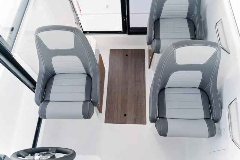 Slide: The Image of Interior helm of 2023 Jeanneau NC 695 Sport S2 boat with scenic water view. - 7